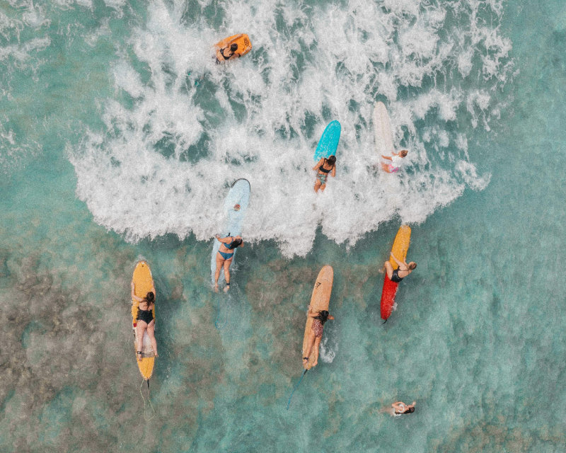 group of ladies on surfboards